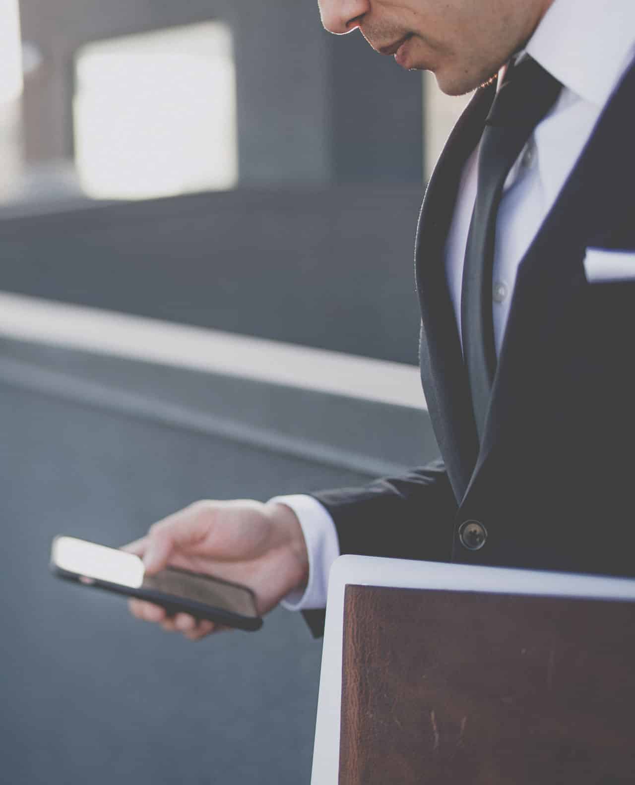 lawyer-using-mobile-phone Laywer with mobile in hand